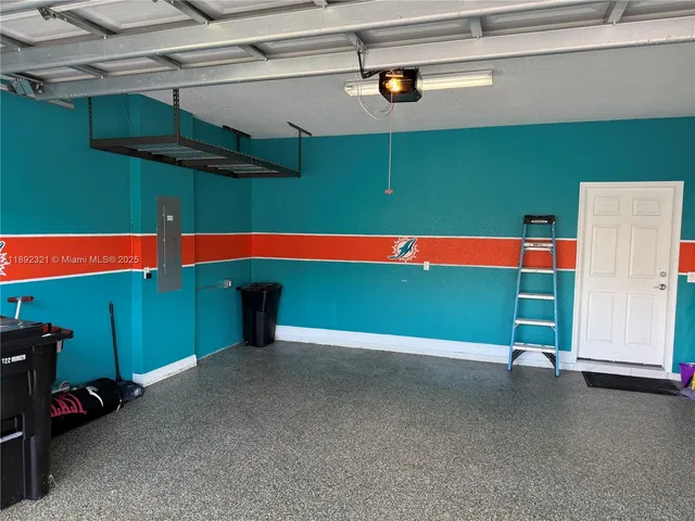 a view of a house with backyard fireplace and sitting area