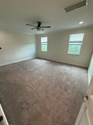 an empty room with a empty space and windows