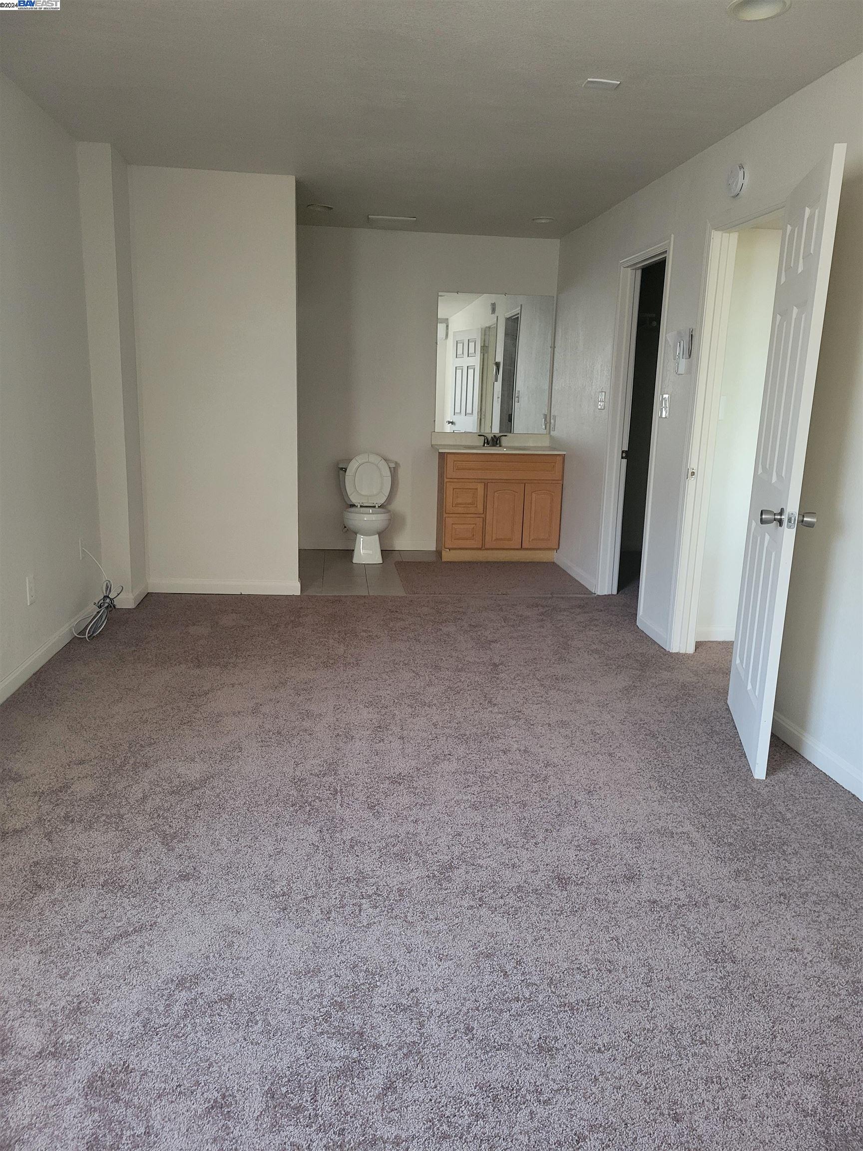 Toler Heights Oakland, CA 94605 - Photo 17 of 18 a view of an empty room with a fireplace and a window