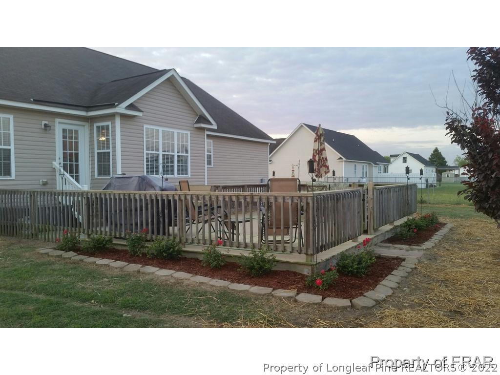 110 Wright Road Vass, NC 28394 - Photo 3 of 31 a view of a house with a small yard and a garden