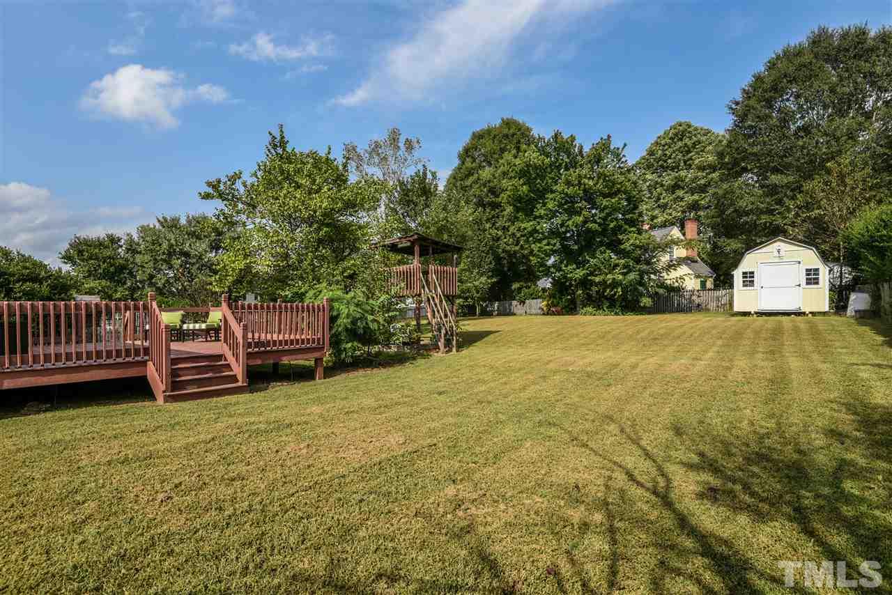 1017 Fairlong Road Wake Forest, NC 27587 - Photo 16 of 17 Showing large deck, open flat space, and storage shed. Great space outside!
