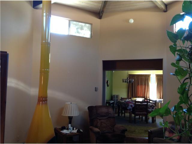 860 Mason Road Vista, CA 92084 - Photo 5 of 13 Living room in the round with free standing fireplace.Open beam rounded ceiling