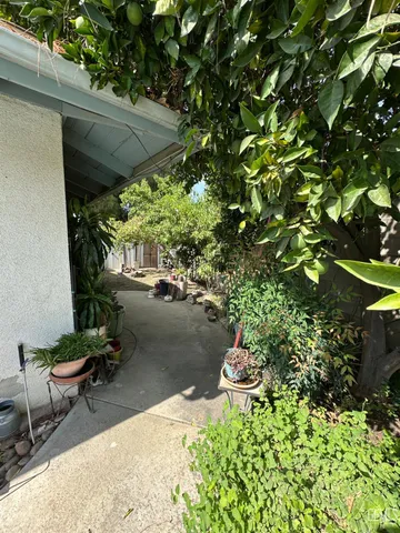 a view of a backyard with chair and a table
