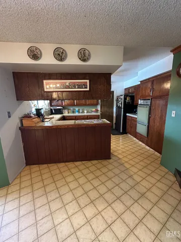 a kitchen with stainless steel appliances granite countertop a sink and cabinets