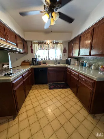a kitchen with stainless steel appliances granite countertop a sink and cabinets