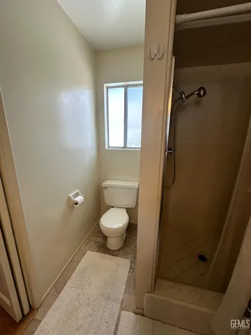 a bathroom with a toilet and a shower