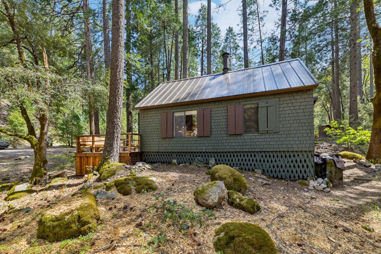 3045 Alder Creek Road, Unit 16 Pollock Pines, CA 95726 - Photo 9 of 20 a view of a house with a wooden fence next to a yard