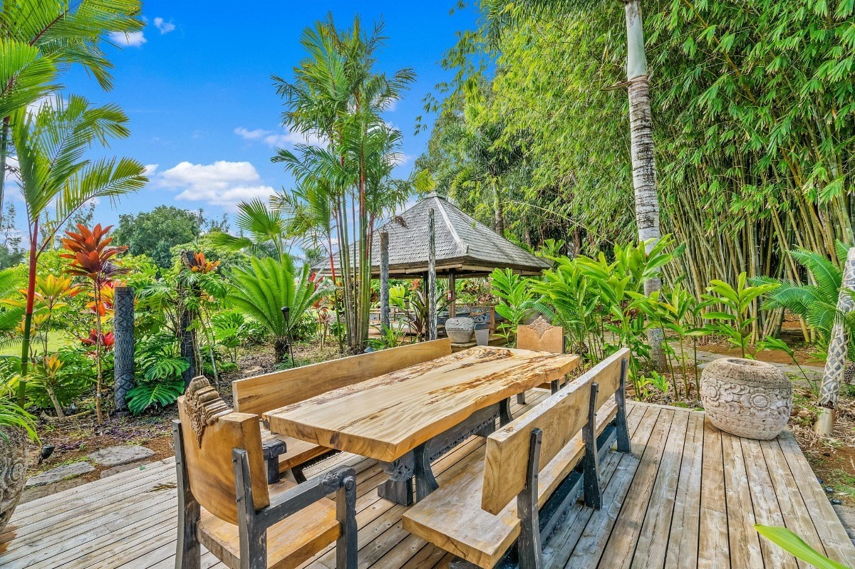 St, Unit 5 Kilauea, HI 96754 - Photo 14 of 26 a patio with table and chairs and potted plants