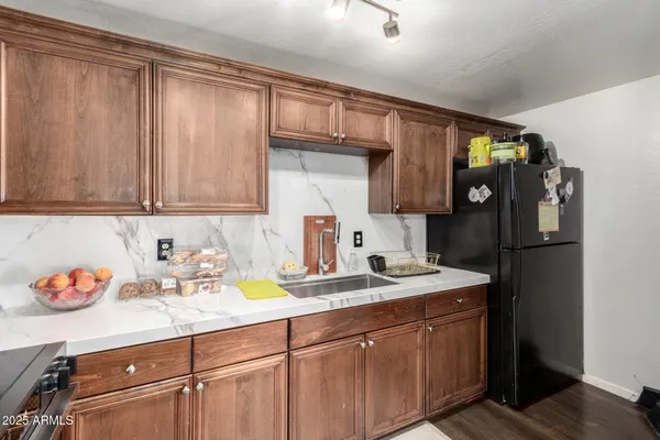a kitchen with a sink cabinets and appliances