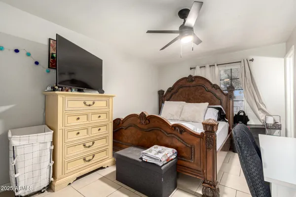 a bedroom with a bed and a flat tv screen