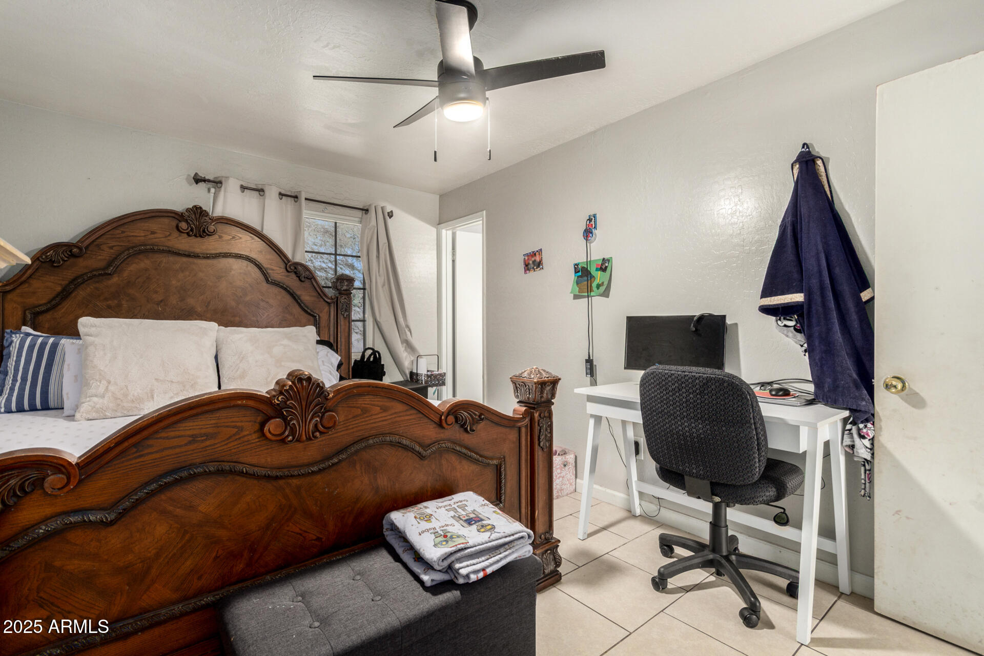 6224 West Berkeley Road Phoenix, AZ 85035 - Photo 16 of 27 a bedroom with a bed and a chandelier