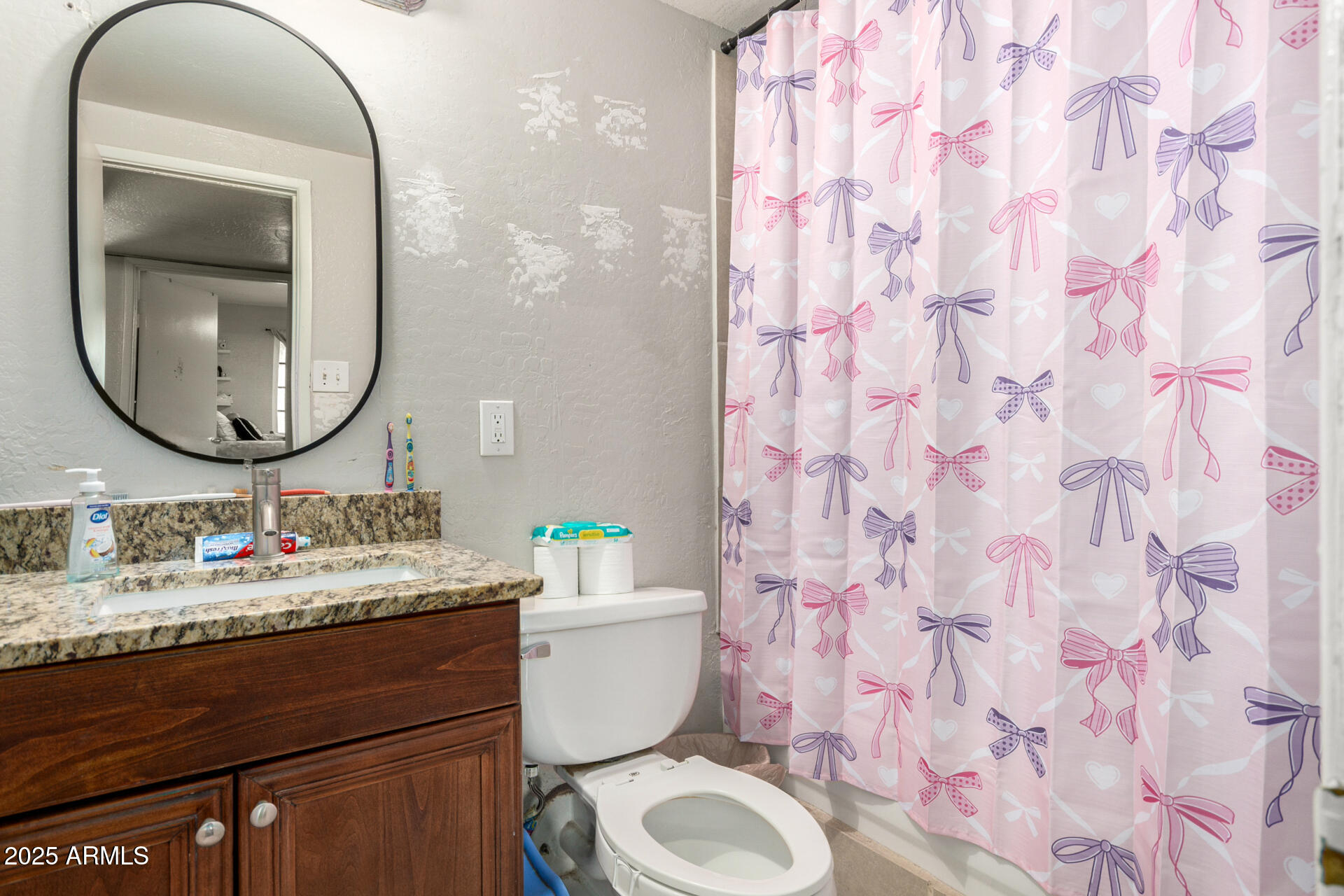 6224 West Berkeley Road Phoenix, AZ 85035 - Photo 20 of 27 a bathroom with a granite countertop sink mirror and toilet