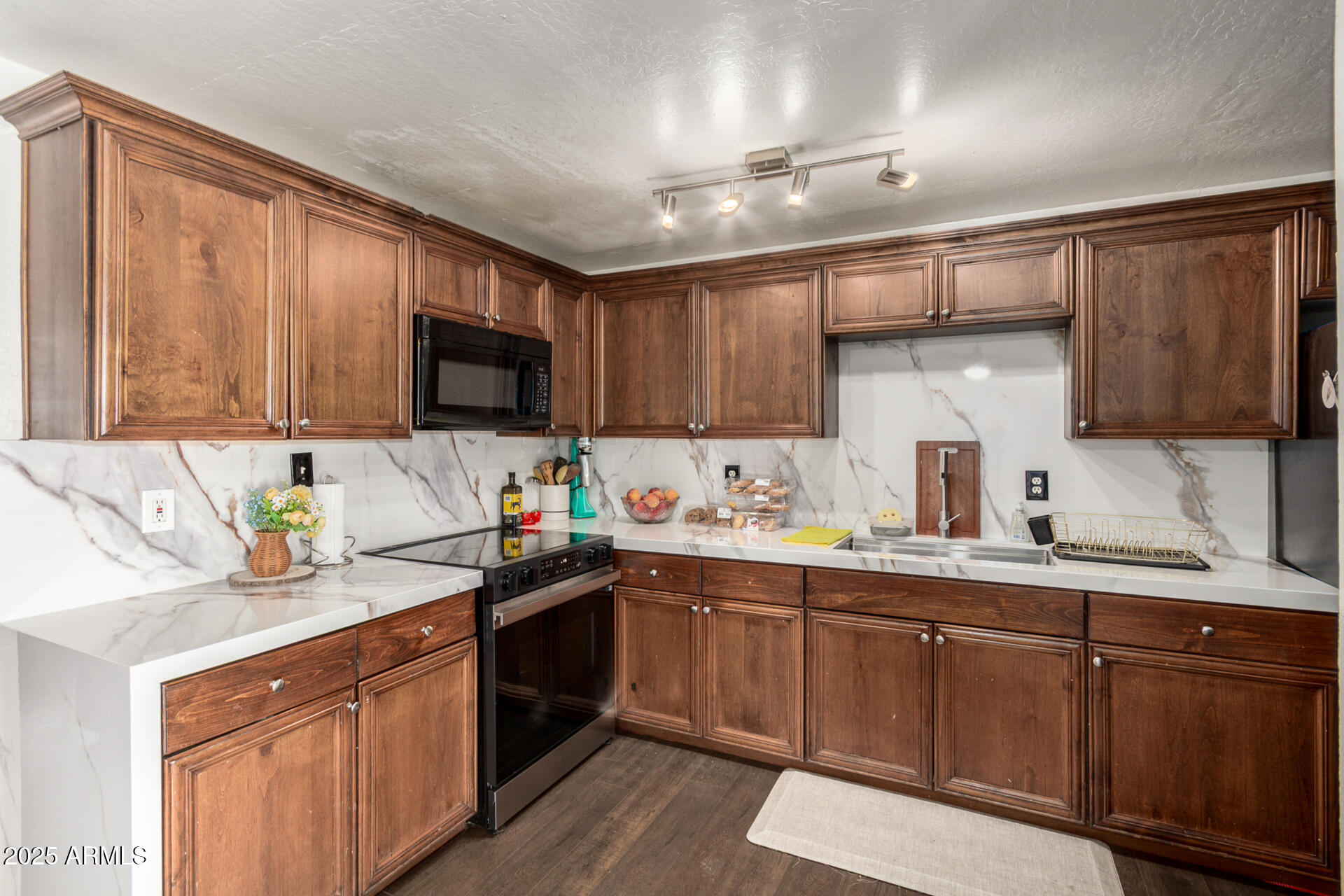 6224 West Berkeley Road Phoenix, AZ 85035 - Photo 8 of 27 a kitchen with kitchen island granite countertop a sink stainless steel appliances and cabinets
