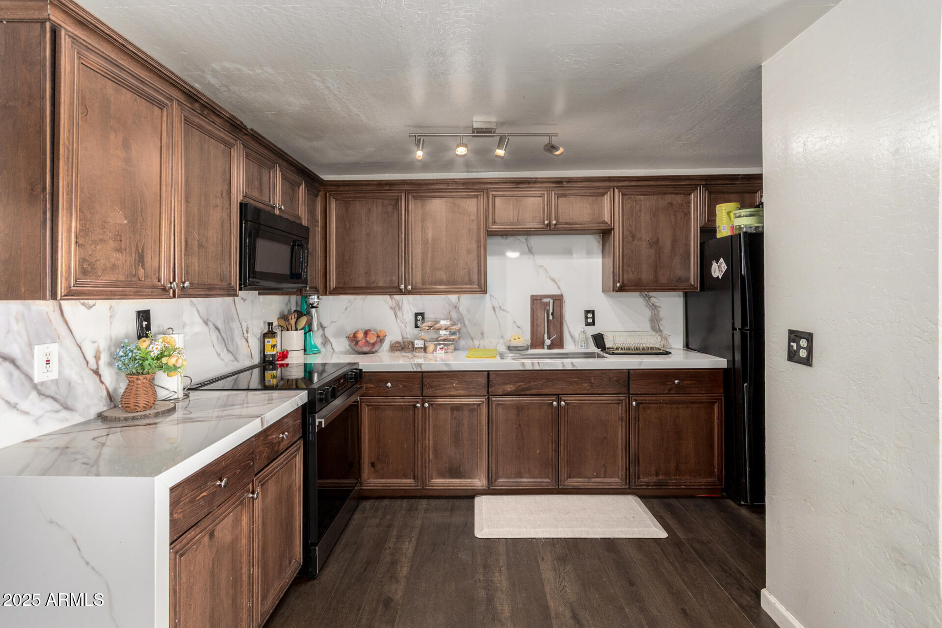 6224 West Berkeley Road Phoenix, AZ 85035 - Photo 9 of 27 a kitchen with stainless steel appliances granite countertop a sink stove and cabinets