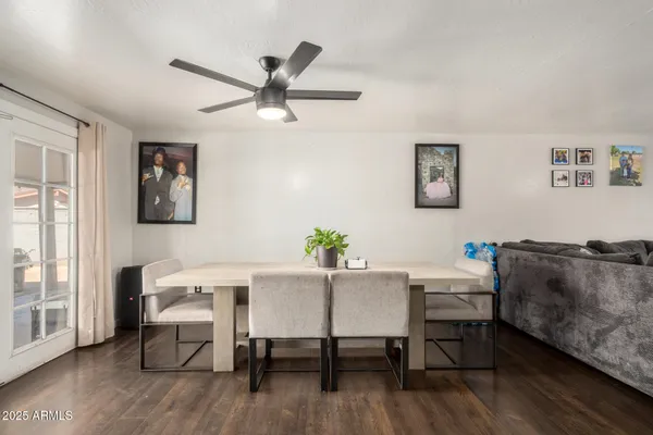 a view of a workspace with furniture and wooden floor