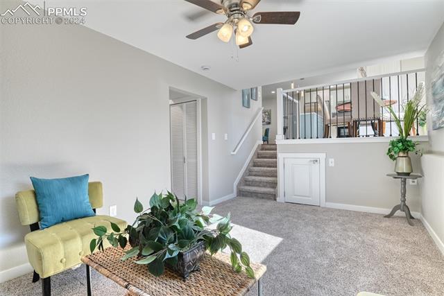 1913 Wooten Road Colorado Springs, CO 80915 - Photo 29 of 50 Sitting room with light colored carpet and ceiling fan
