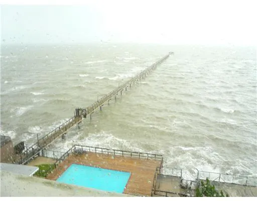 a dining room with lots of furniture and a large window