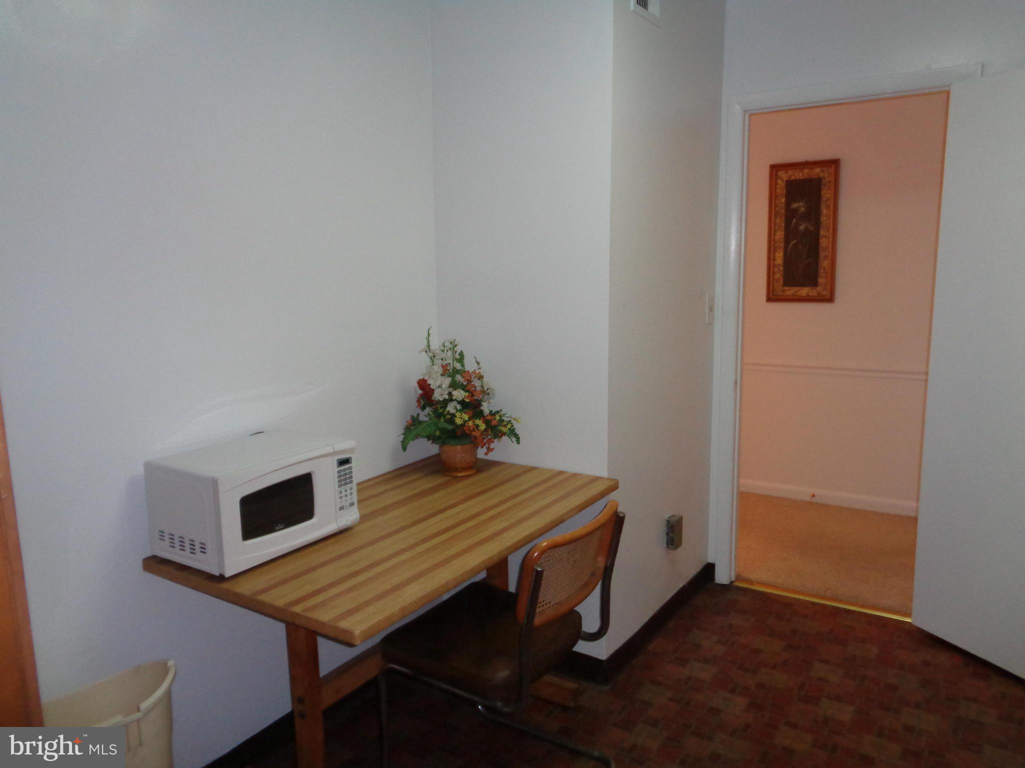 7 Cross Keys Road, Unit 7F Baltimore, MD 21210 - Photo 12 of 27 a room with furniture and wooden floor