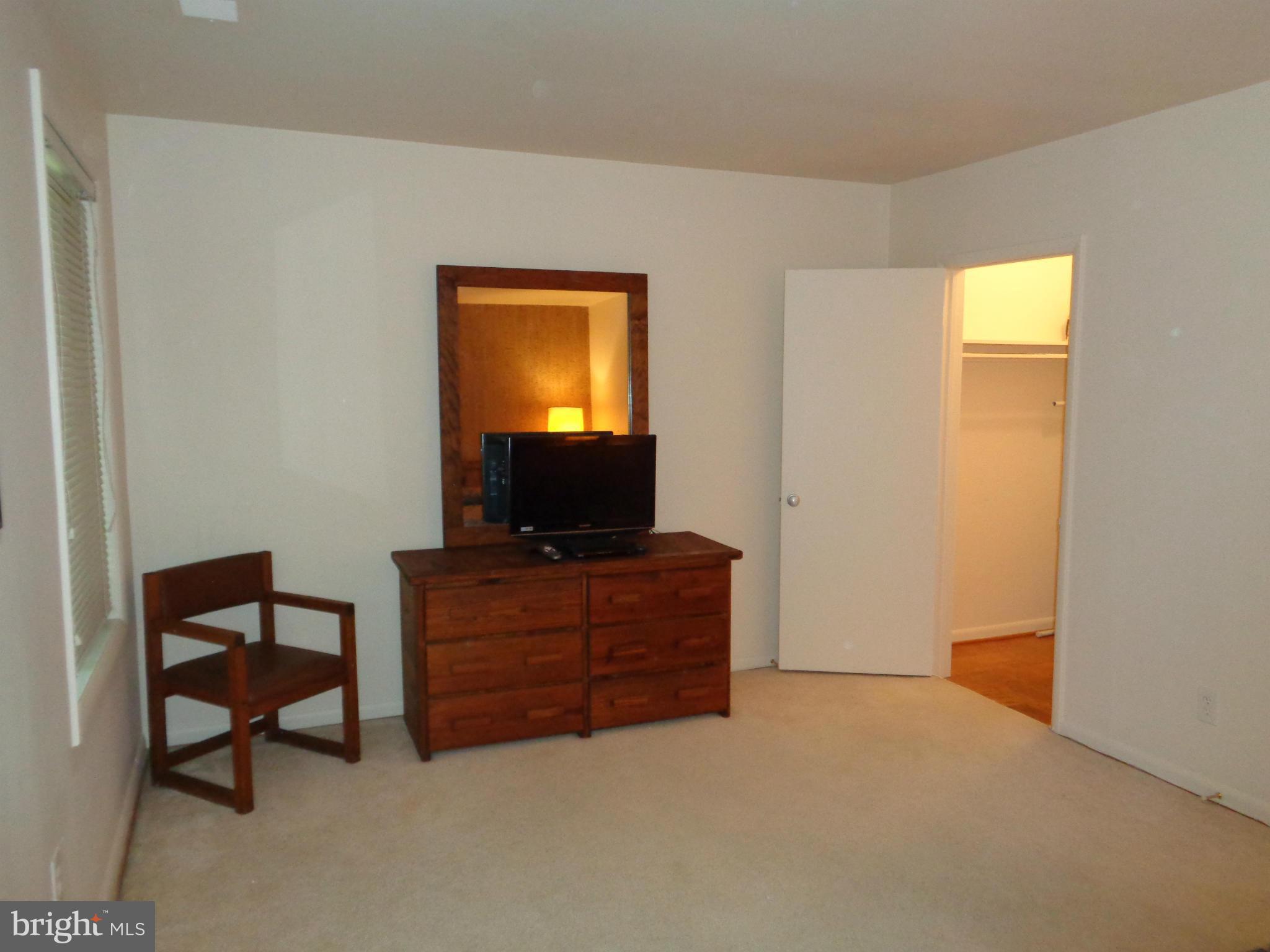 7 Cross Keys Road, Unit 7F Baltimore, MD 21210 - Photo 16 of 27 a living room with furniture and a flat screen tv