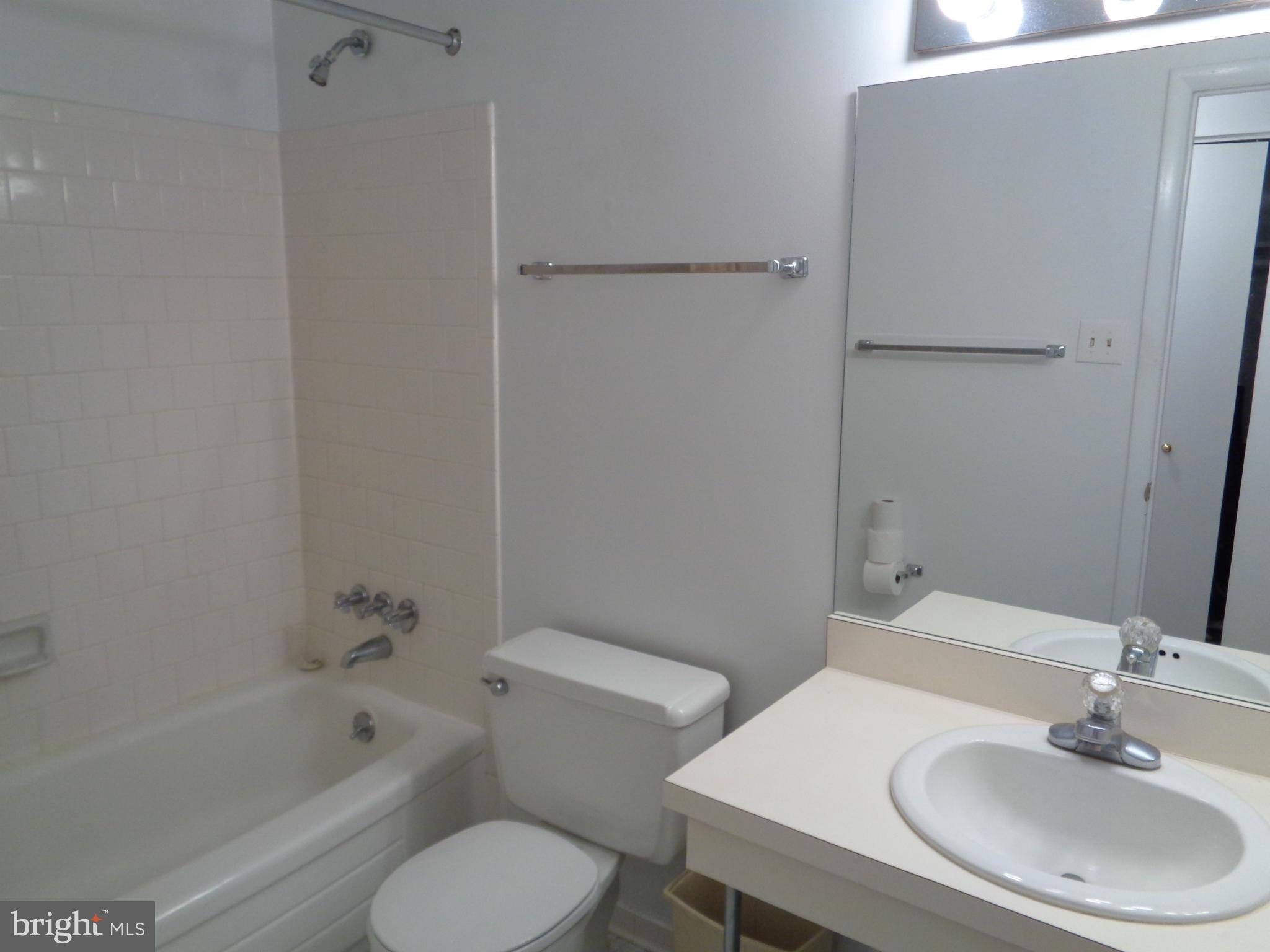 7 Cross Keys Road, Unit 7F Baltimore, MD 21210 - Photo 18 of 27 a bathroom with a sink toilet and shower