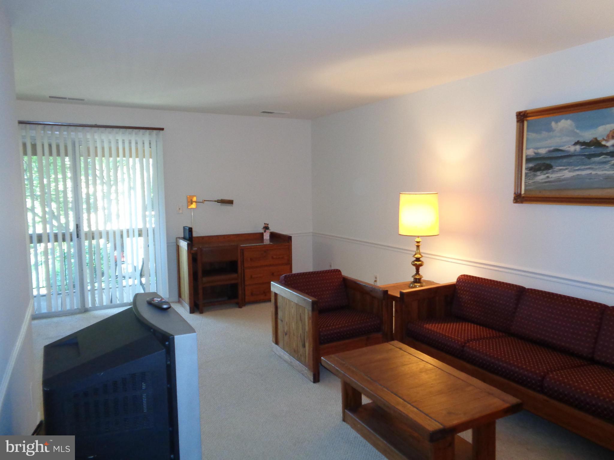 7 Cross Keys Road, Unit 7F Baltimore, MD 21210 - Photo 3 of 27 a living room with furniture and a window