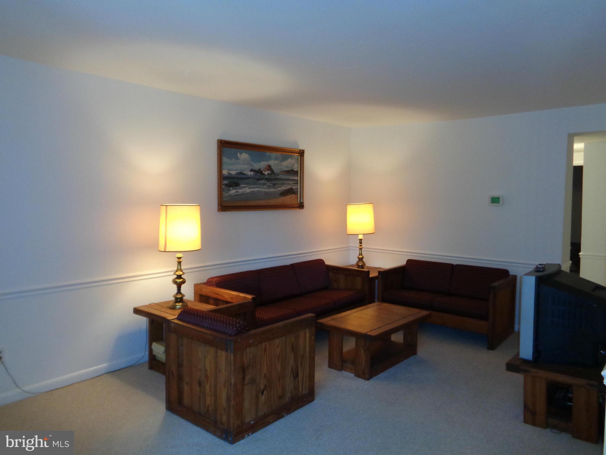 7 Cross Keys Road, Unit 7F Baltimore, MD 21210 - Photo 4 of 27 a living room with furniture and a flat screen tv