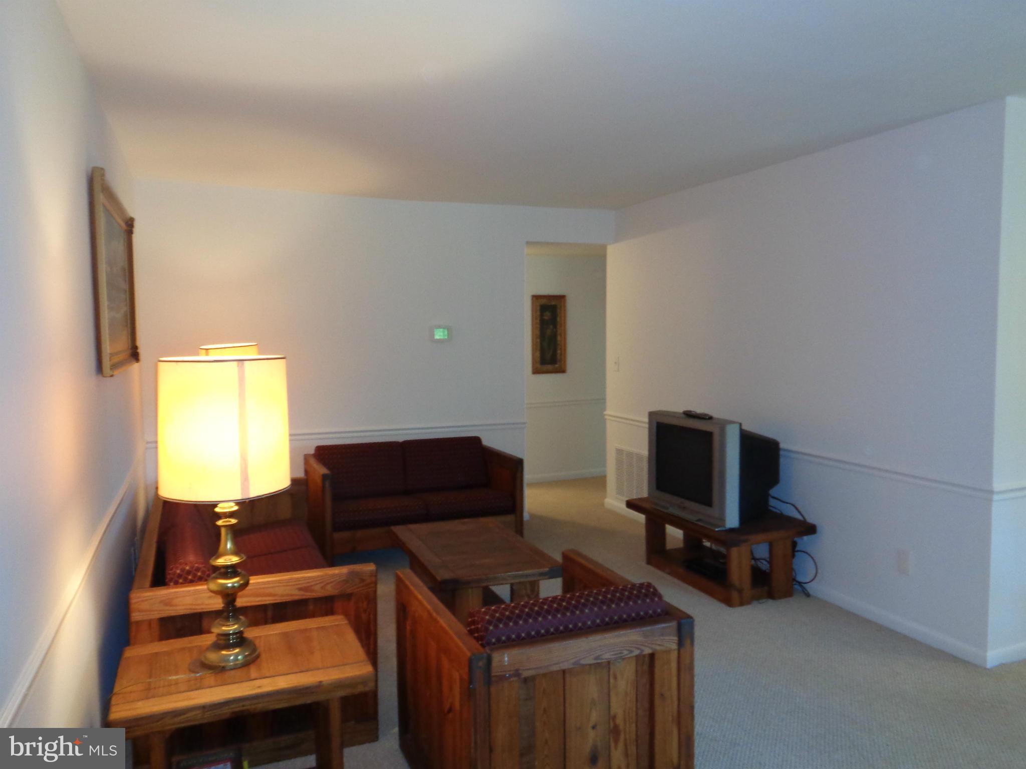 7 Cross Keys Road, Unit 7F Baltimore, MD 21210 - Photo 5 of 27 a living room with furniture and a flat screen tv