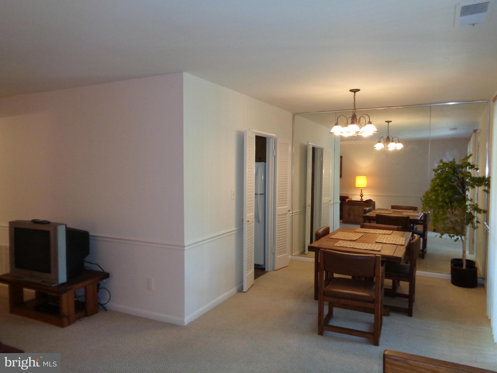 7 Cross Keys Road, Unit 7F Baltimore, MD 21210 - Photo 6 of 27 a room with furniture and a chandelier