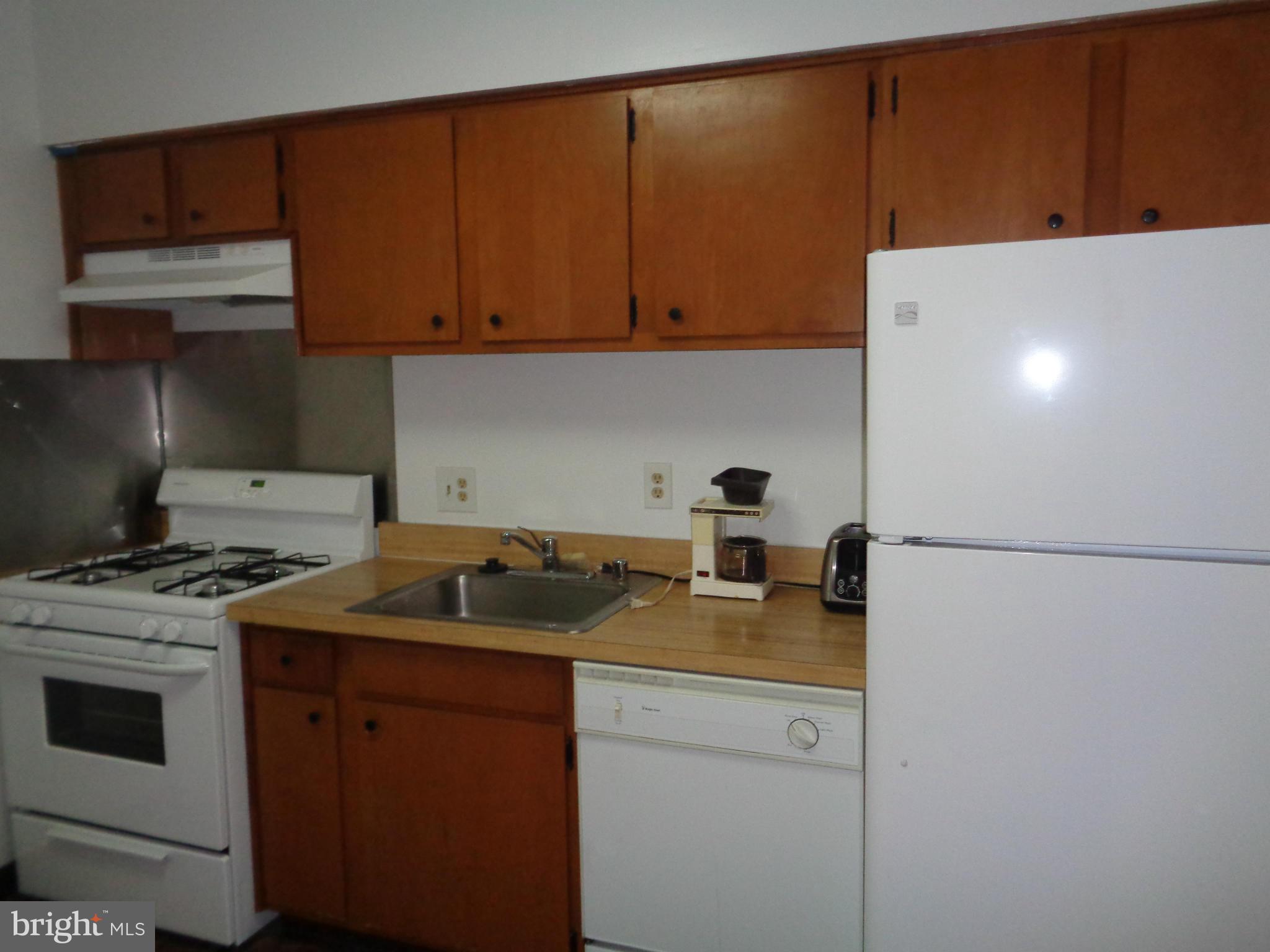 7 Cross Keys Road, Unit 7F Baltimore, MD 21210 - Photo 10 of 27 a kitchen with a sink a stove and refrigerator