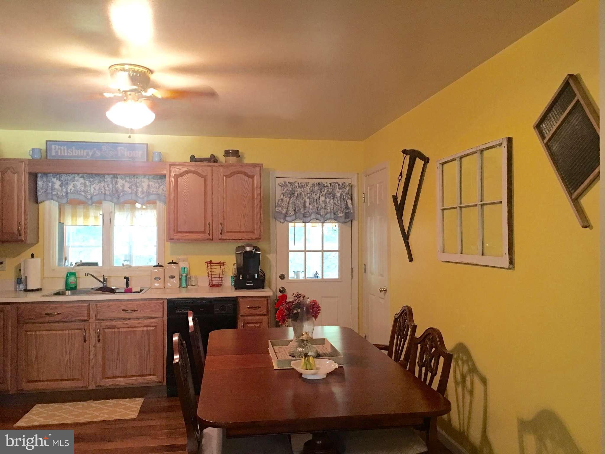 44099 Sandy Bottom Road Hollywood, MD 20636 - Photo 2 of 30 a view of a dining room with furniture and window