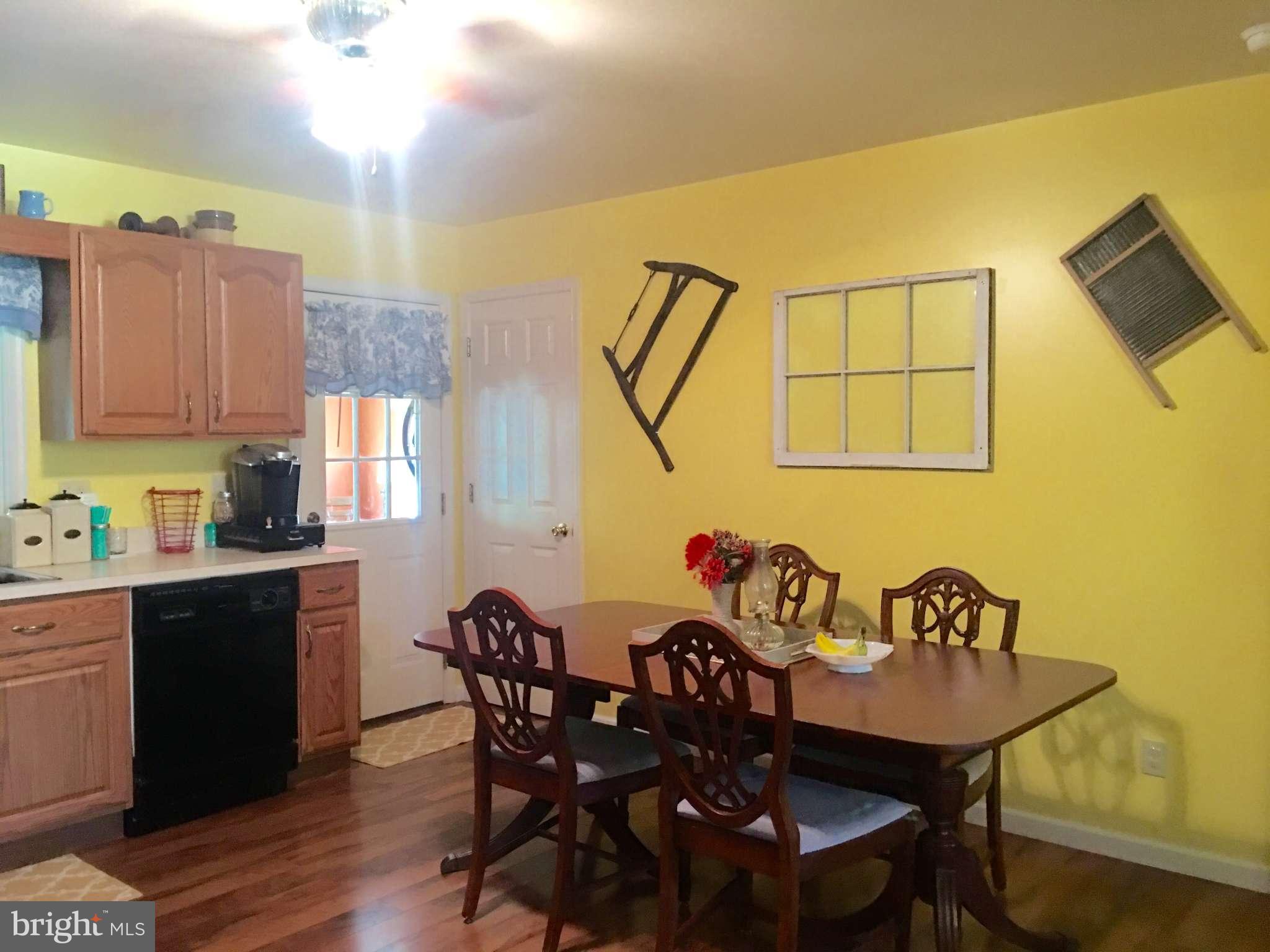 44099 Sandy Bottom Road Hollywood, MD 20636 - Photo 5 of 30 a view of a dining room with furniture and wooden floor