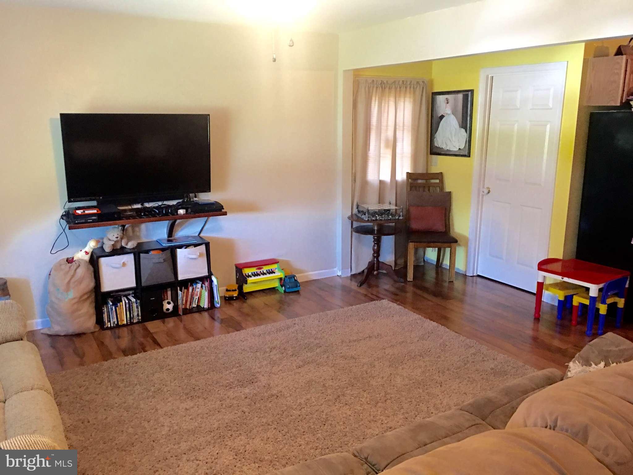 44099 Sandy Bottom Road Hollywood, MD 20636 - Photo 6 of 30 a living room with furniture and a flat screen tv
