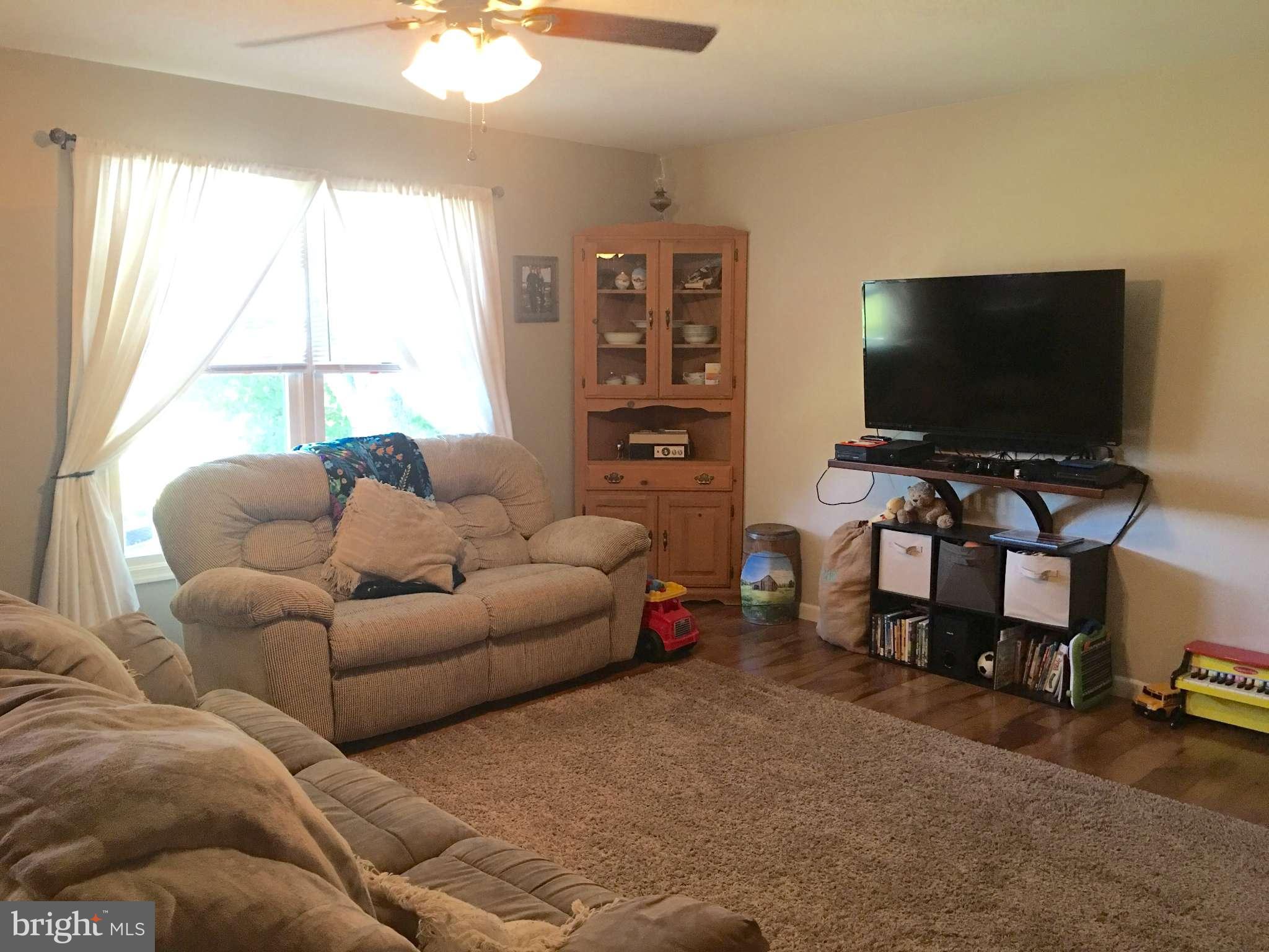 44099 Sandy Bottom Road Hollywood, MD 20636 - Photo 7 of 30 a living room with furniture and a flat screen tv