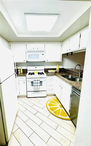 a kitchen with stainless steel appliances a stove a sink and a refrigerator