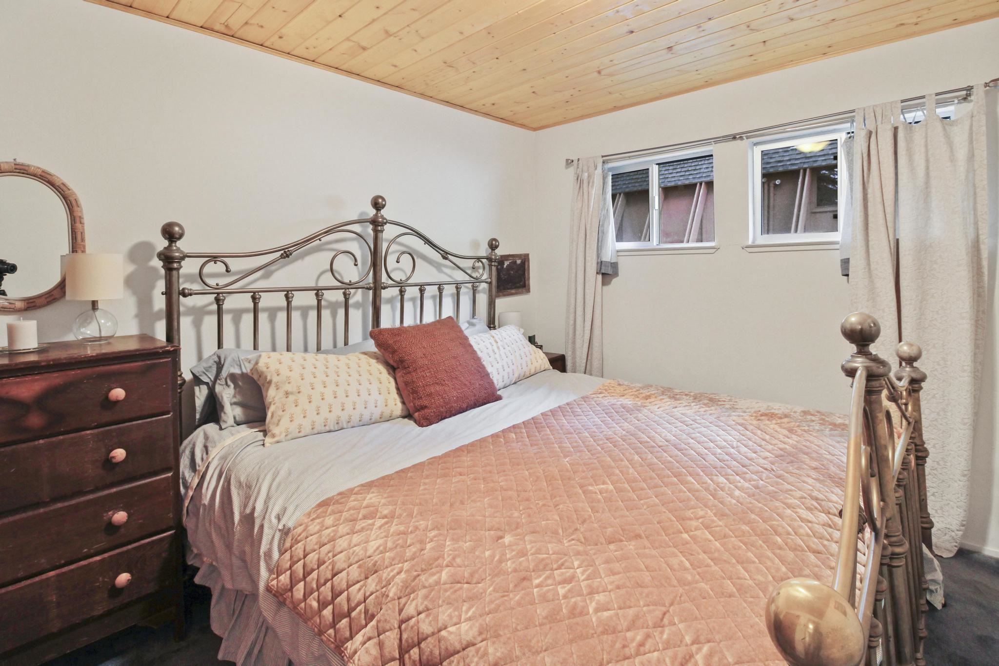 1503 Alpine Meadows Road Alpine Meadows, CA 96146 - Photo 13 of 28 a bedroom with a bed a dresser and a window