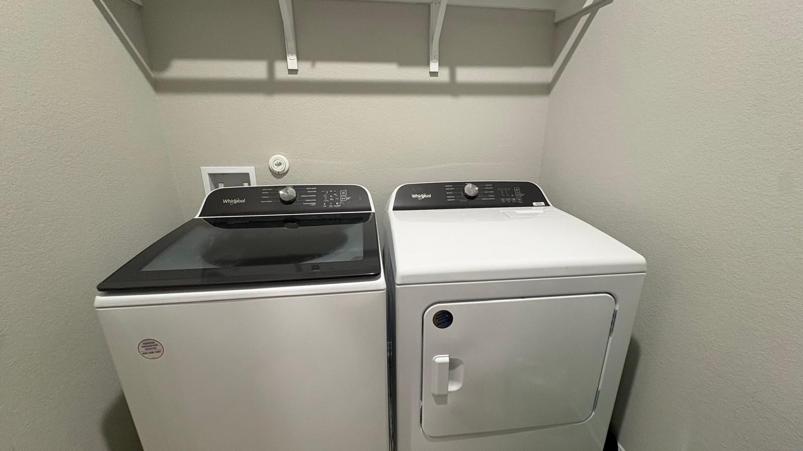 6511 Dragride Road Buda, TX 78610 - Photo 29 of 36 Functional laundry space featuring modern appliances and convenient overhead shelving.
