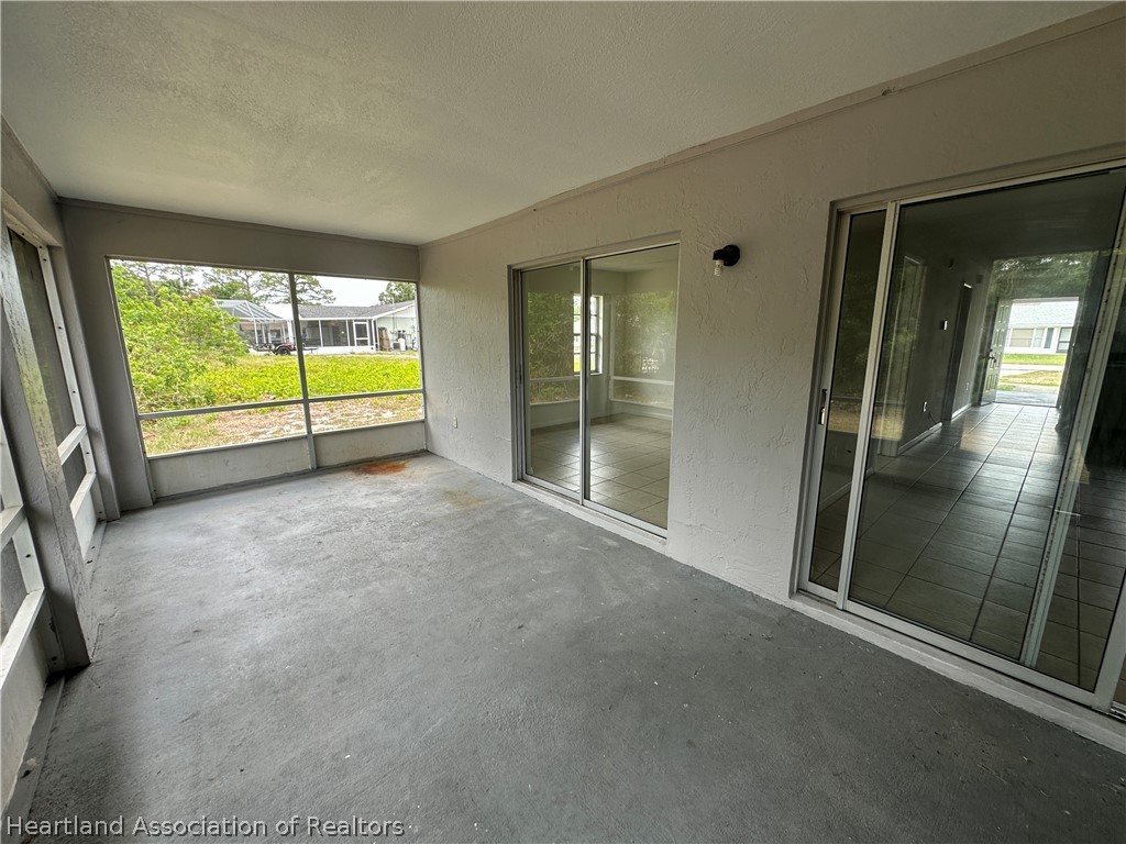 237 Rhapsody Avenue Lake Placid, FL 33852 - Photo 14 of 18 a view of an empty room with a sliding door