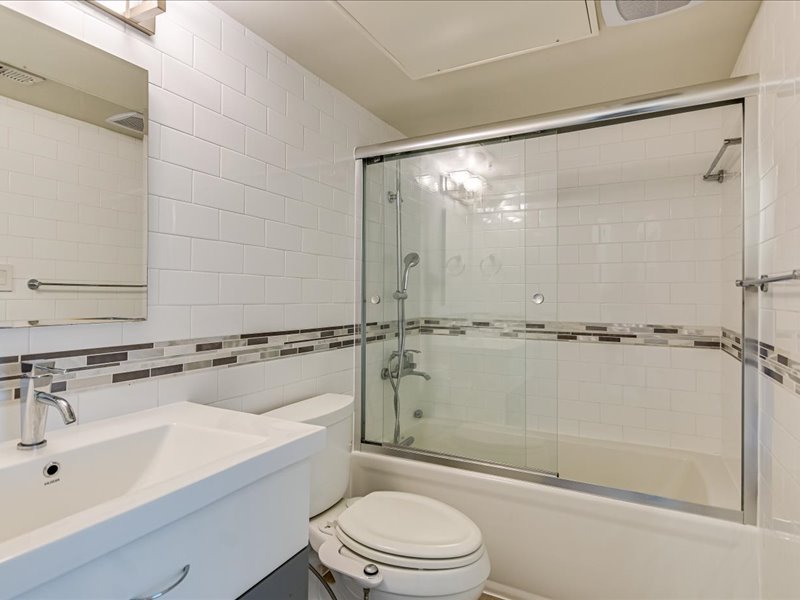 3110 Red River Street, Unit D212 Austin, TX 78705 - Photo 11 of 20 a bathroom with a sink mirror shower and toilet