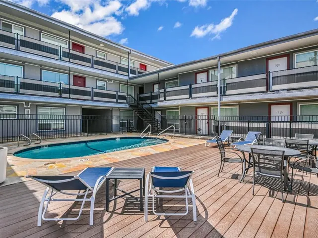 a patio with swimming pool table and chairs