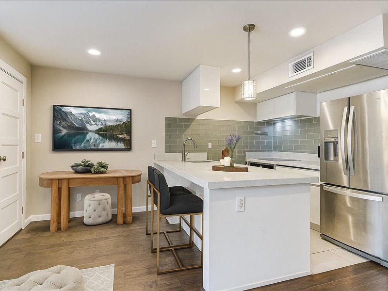 3110 Red River Street, Unit D212 Austin, TX 78705 - Photo 4 of 20 a kitchen with stainless steel appliances granite countertop a sink stove and refrigerator