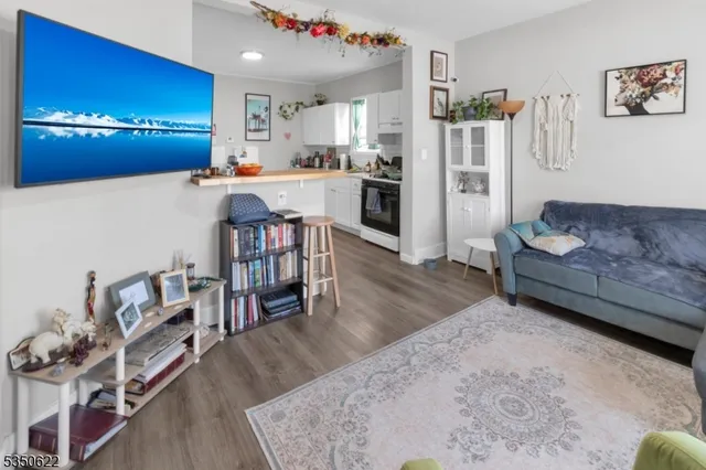 a living room with furniture and a chandelier