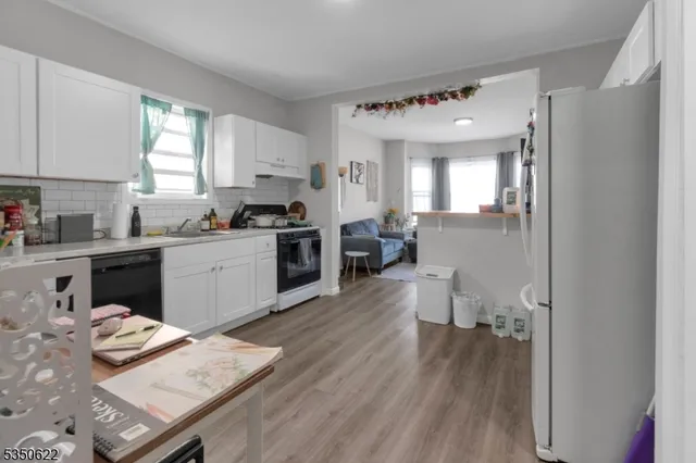 a kitchen with a sink cabinets and wooden floor