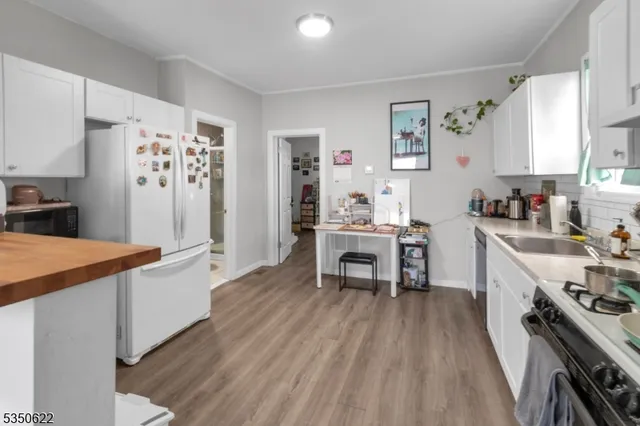 a kitchen with stainless steel appliances a stove a sink dishwasher and a refrigerator