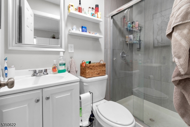 26 Grand Street, Unit 1 Garfield, NJ 07026 - Photo 6 of 9 a bathroom with a sink toilet and shower