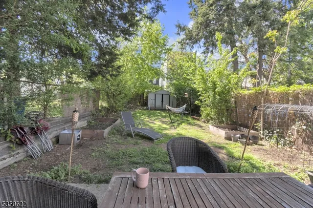 a view of a deck with couches table and chairs and potted plants
