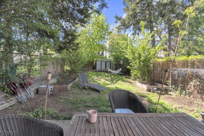 26 Grand Street, Unit 1 Garfield, NJ 07026 - Photo 8 of 9 a view of a deck with couches table and chairs and potted plants