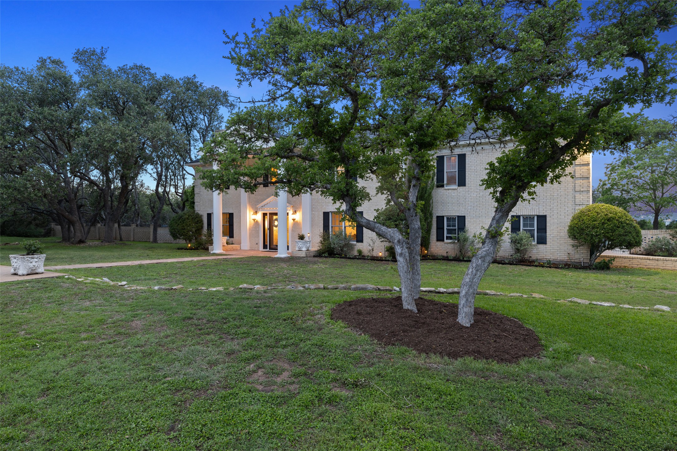 17700 North Rim Drive Leander, TX 78641 - Photo 3 of 38 Greek revival inspired property featuring a front yard and brick siding