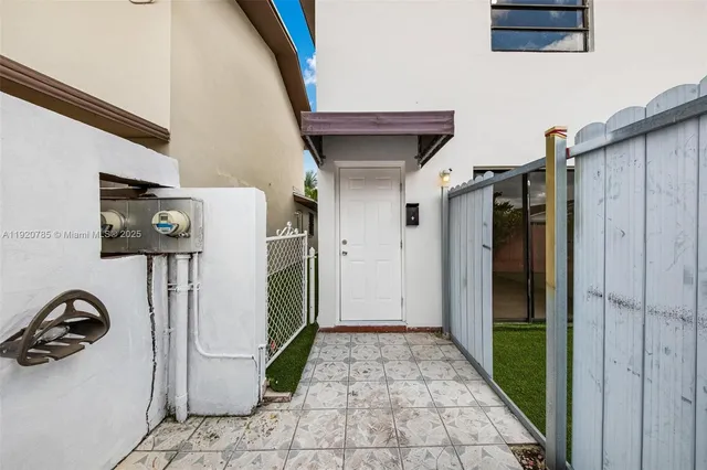 a aerial view of a house with a yard and potted plants