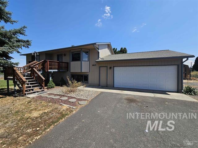 1825 Cedar Avenue Lewiston, ID 83501 - Photo 1 of 39 View of front of home with driveway, an attached garage, stairs, and a wooden deck