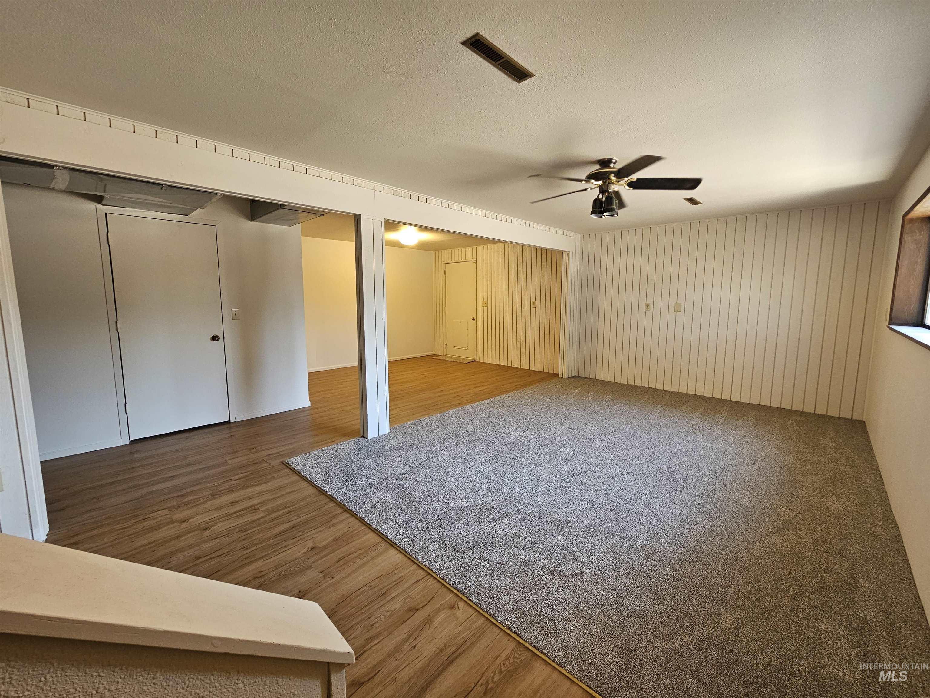 1825 Cedar Avenue Lewiston, ID 83501 - Photo 21 of 39 Unfurnished bedroom with light wood-style flooring, two closets, a ceiling fan, and a textured ceiling